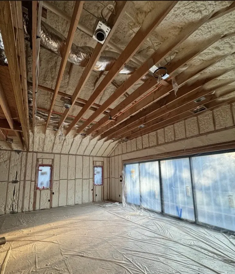 Interior walls and ceiling insulated with spray foam during new construction in Wellington